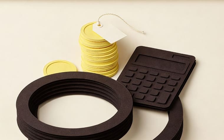Paper craft illustration of a jeweller at the counter comparing two software quotes side by side, with a phone showing a gold scheme app