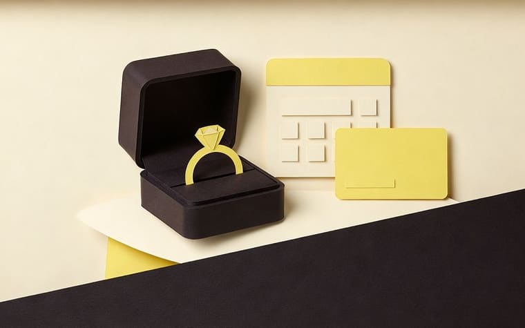 Paper craft illustration of a jewelry store counter with a phone showing a payment reminder by text and email and a calendar of layaway due dates